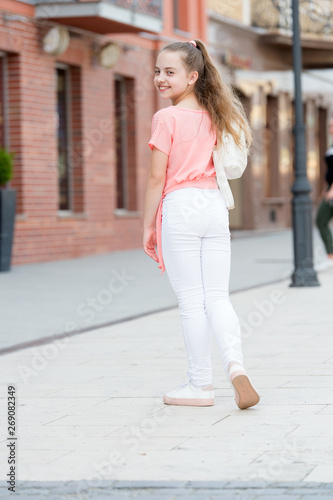 Kid long hair enjoy walk sunny day. Summer holidays relax. Charming stylish fashionable girl. Little child enjoy walk. Summer is here. Summer vacation and tourism. Girl carefree child. Happy day