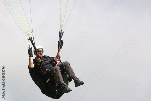 Paraglider flying in his harness