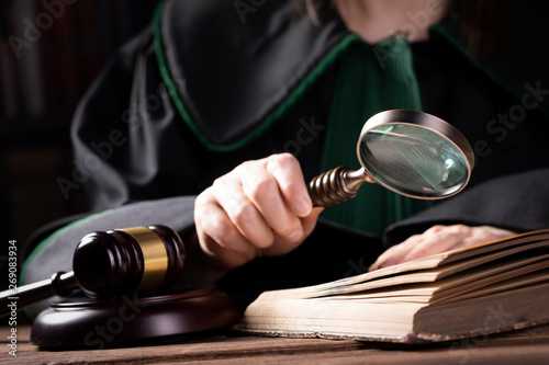 Lawer holding magnifying glass. Criminal case investigation