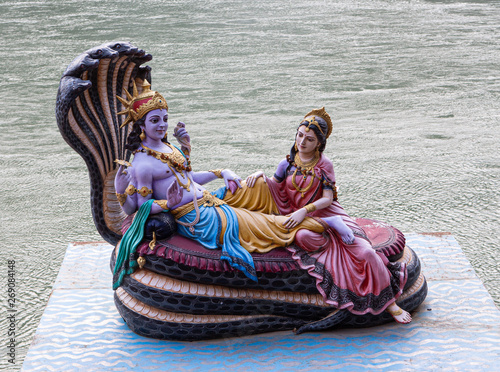 Statue of Vishnu and Lakshmi on the Ganges coast in Rishikesh photo