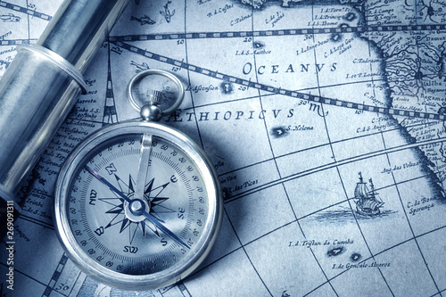 compass and spyglass on medieval map