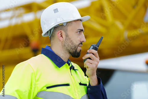 construction worker on site using walkie talkie