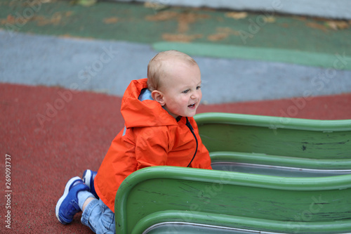 Baby Boy Climbing Up On Slide