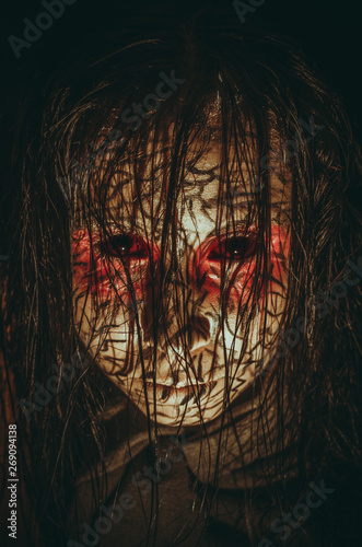 Demon girl with red eyes and cracked skin close-up portrait