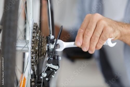 repair specialist fixing wheel of bike