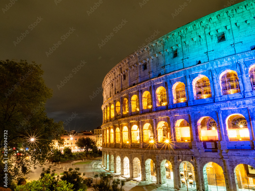 A night time picture of Oval amphitheatre in the centre of the city of Rome, Italy with light and full moon