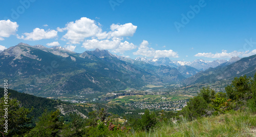 Spectacular view of a large valley under the towering mountain range in France.