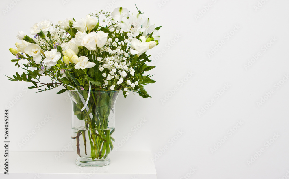 White flowers on glass vase home decoration. White flowers on glass vase home decoration.