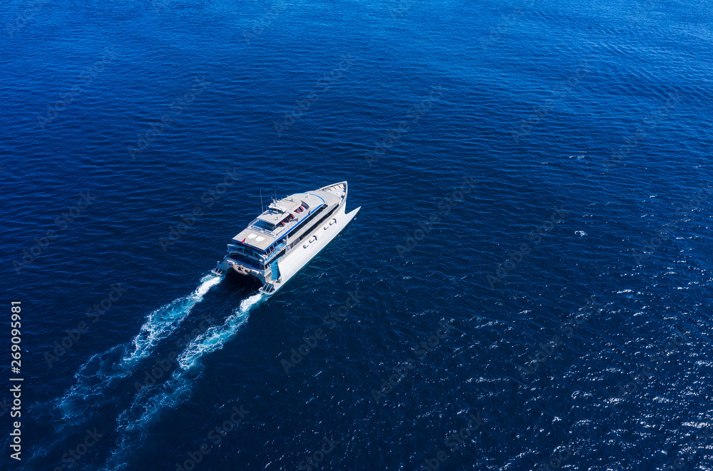 Aerial view of luxury floating cruise ship on transparent turquoise water at sunny day. Summer seascape from air. Top view from drone. Seascape with cruise ship. Travel - image Aerial view of luxury floating cruise ship on transparent turquoise water at sunny day. Summer seascape from air. Top view from drone. Seascape with cruise ship. Travel - image