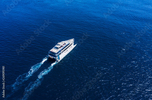 Aerial view of luxury floating cruise ship on transparent turquoise water at sunny day. Summer seascape from air. Top view from drone. Seascape with cruise ship. Travel - image © biletskiyevgeniy.com
