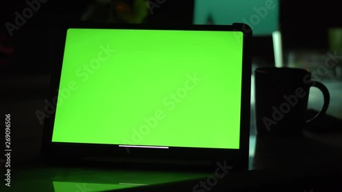 Dolly shot of Tablet computer with green screen chroma key.