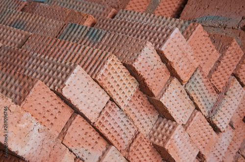 The wall is made of bricks. Brickwork in the construction of a new building. The use of a classic building material. © Vasiliy Ulyanov