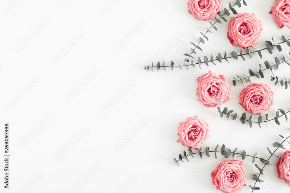 Beautiful flowers composition. Eucalyptus leaves and branches, pink rose flowers on white background. Valentines Day, Easter, Birthday, Happy Women's Day, Mother's day. Flat lay, top view, copy space Beautiful flowers composition. Eucalyptus leaves and branches, pink rose flowers on white background. Valentines Day, Easter, Birthday, Happy Women's Day, Mother's day. Flat lay, top view, copy space