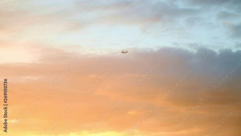 Airplane Flying Across Peach Sunset Clouds Airplane Flying Across Peach Sunset Clouds