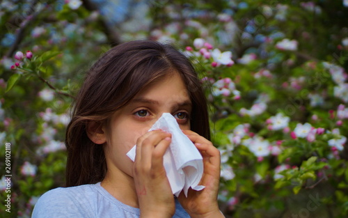 young girl blowing her nose - allergy
