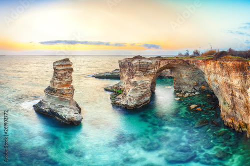 Dramatic seascape with cliffs, rocky arch at Torre Sant Andrea