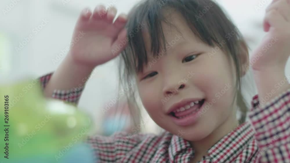 Cute asian little girl playing with mother at home. Asian girl count as a glass ball with smile face . Cute asian little girl playing with mother at home. Asian girl count as a glass ball with smile face .