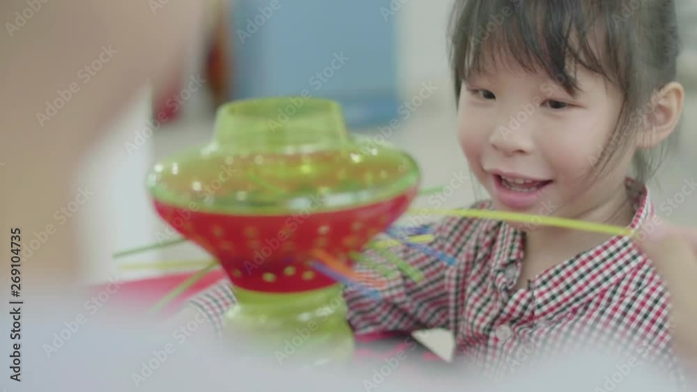 Cute asian little girl playing with mother at home. Asian girl count as a glass ball with smile face . Cute asian little girl playing with mother at home. Asian girl count as a glass ball with smile face .