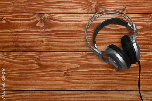 Vintage headphones for listening to sound and music on a wooden background