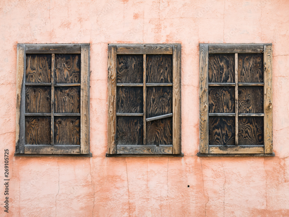 Three boarded up cabin windows at Mormon row in Wyoming