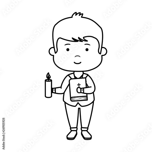little boy with bible and candle first communion