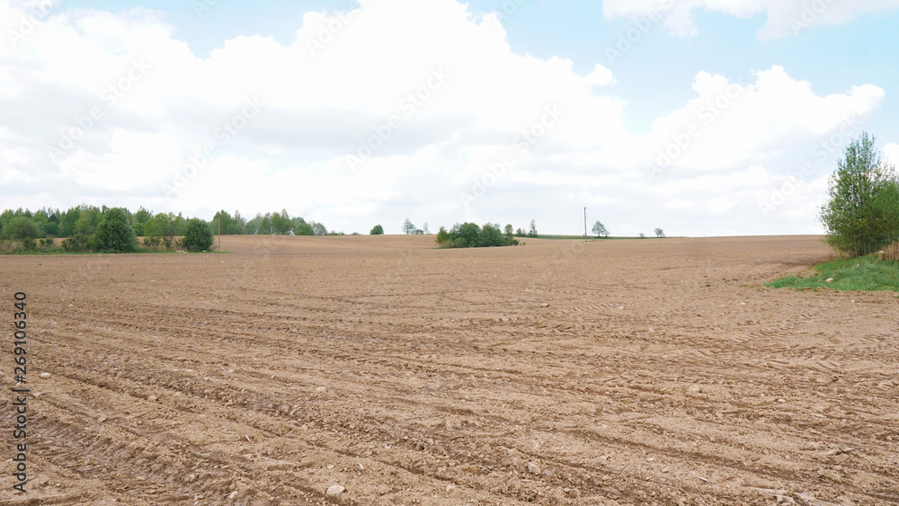 Landscape with agricultural land, recently plowed and prepared for the crop