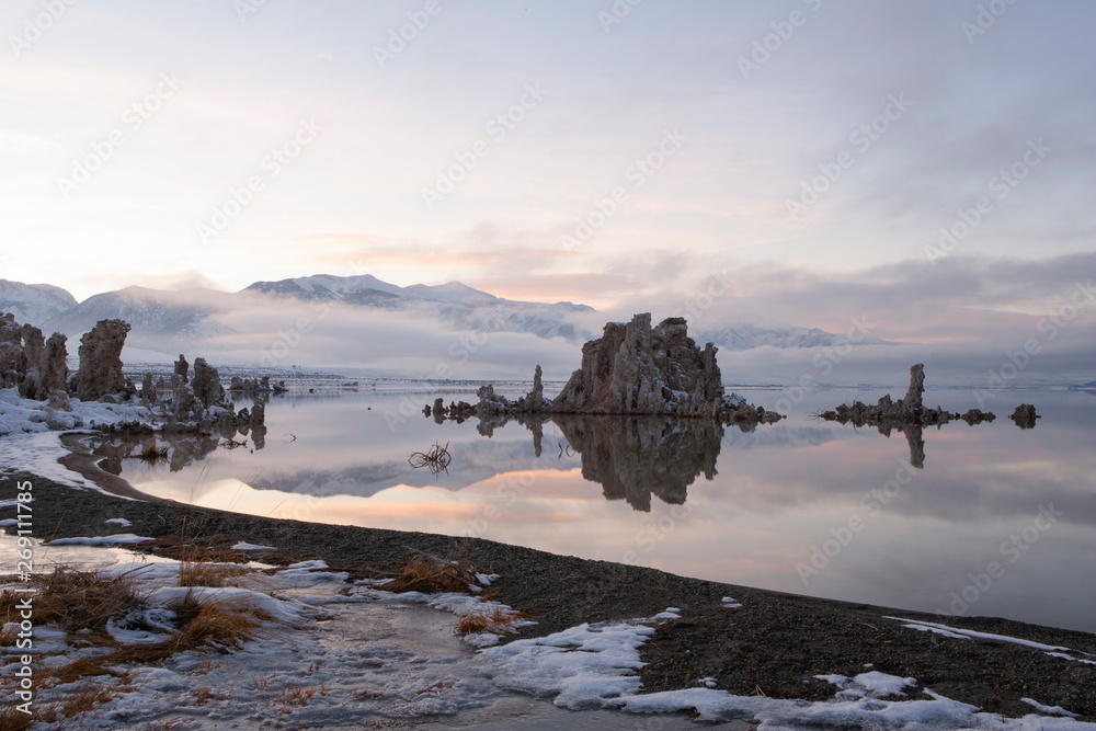 Mono Lake is one of many unique landscapes on the southern part of California. During winter season this area is most often cover in thick tule fog. You can see the low fog moving in  on the mountain 