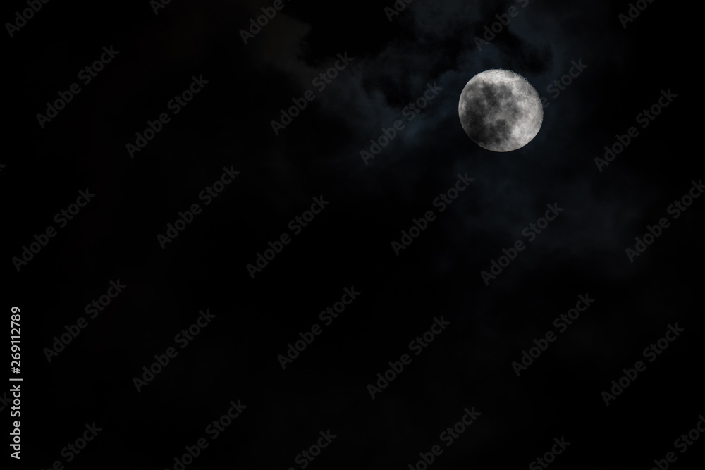 Moon with light cloud cover in the sky