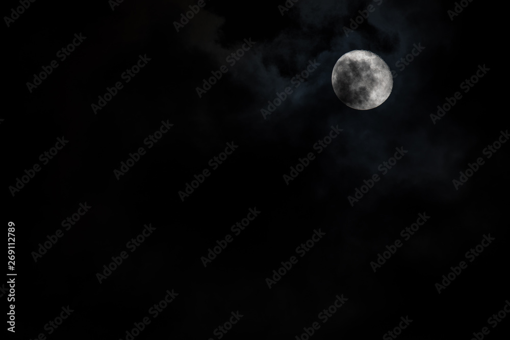 Moon with light cloud cover in the sky Moon with light cloud cover in the sky
