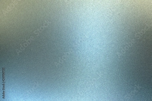 Glowing brushed blue metal wall surface, abstract texture background