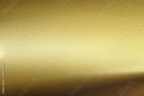 Light shining on rough gold metal wall, abstract texture background