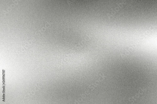 Light shining on wave silver metal wall, abstract texture background