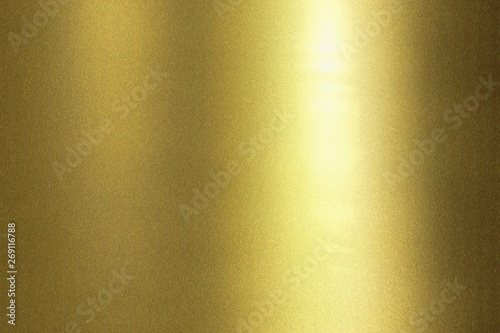 Light shining on wave golden metal wall, abstract texture background