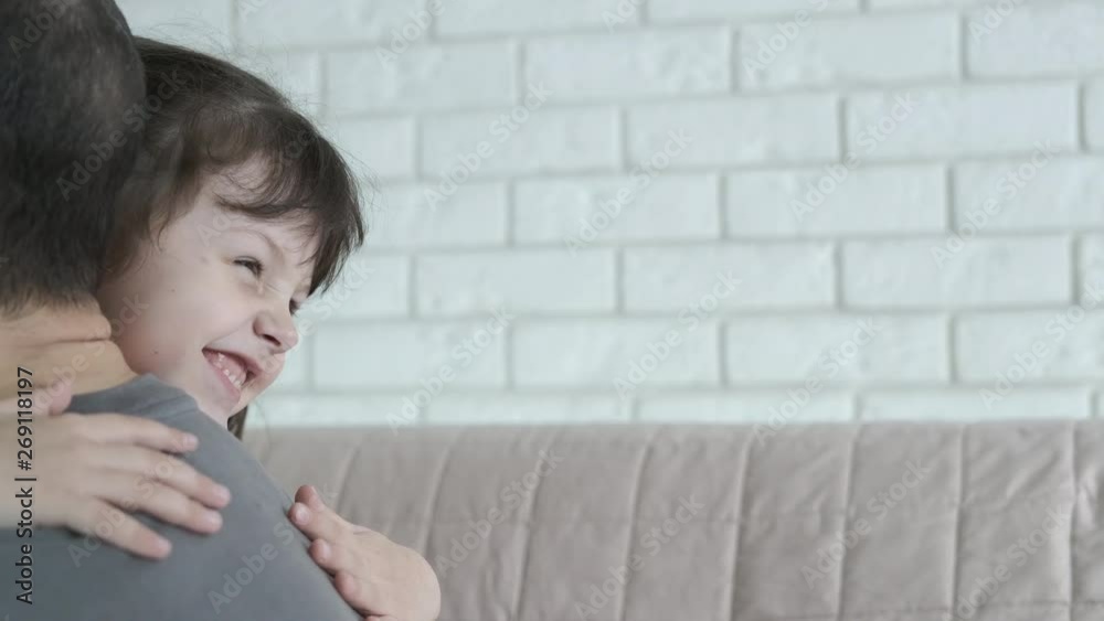 A child hugs dad. Happy little girl hugs dad. A child hugs dad. Happy little girl hugs dad.