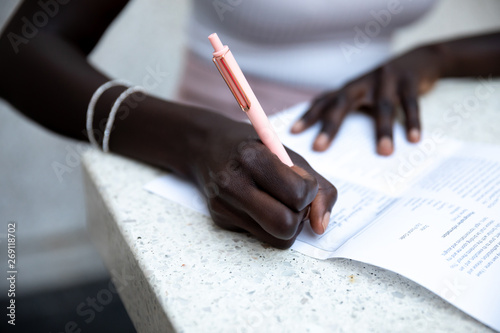 hands writing on a piece of paper photo