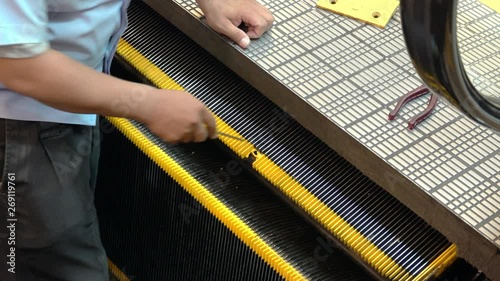 Technician fix the escalator at shopping mall