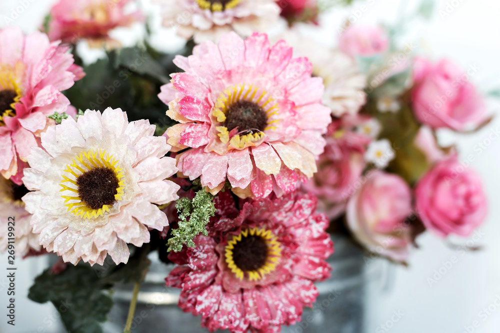 Artificial flower in the pot over wood table Artificial flower in the pot over wood table