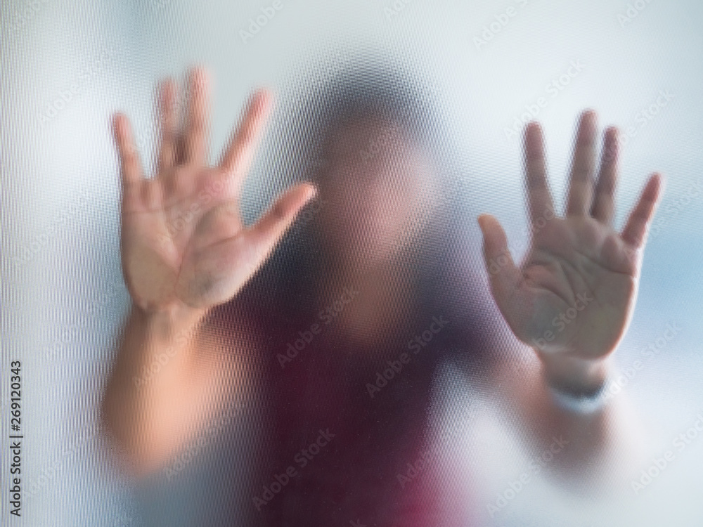 Blurry woman hand behind frosted glass metaphor panic and negative dark emotional