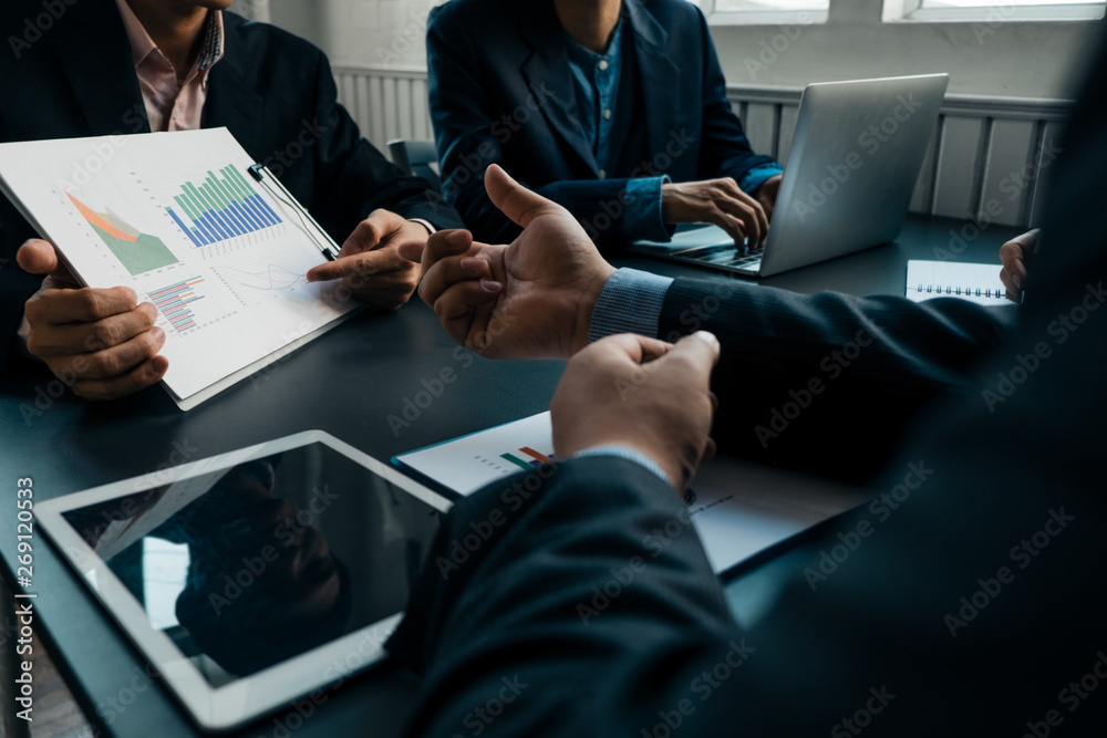 Businesspeople analyzing investment graph meeting brainstorming and discussing plan in meeting room, investment concept Businesspeople analyzing investment graph meeting brainstorming and discussing plan in meeting room, investment concept