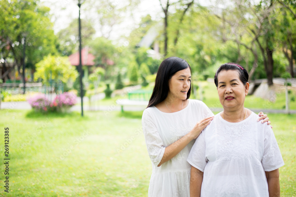 Portrait of a elderly asian women with young women walking at park together,Positive thinking Portrait of a elderly asian women with young women walking at park together,Positive thinking