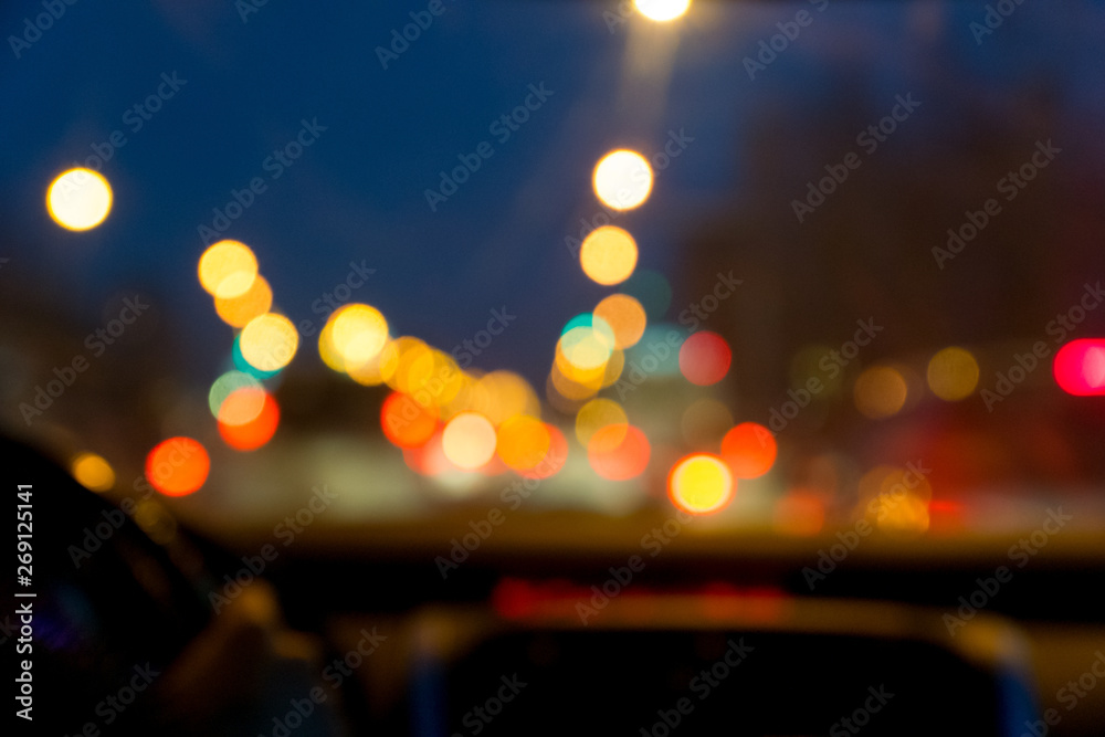 defocused city night street view from car front window