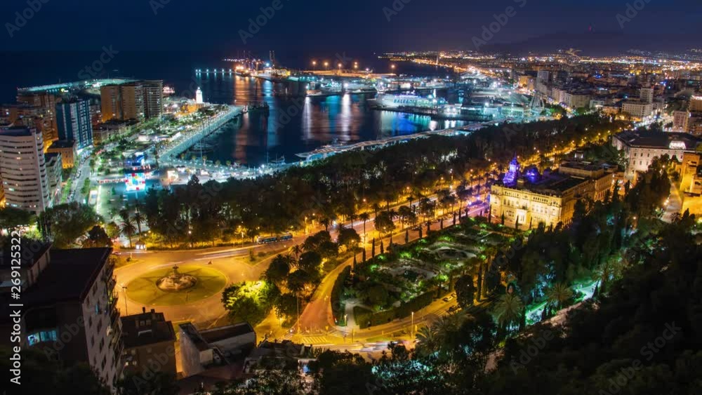 Aerial view of port, buildings and city lights reflecting in ocean, Malaga Spain Aerial view of port, buildings and city lights reflecting in ocean, Malaga Spain