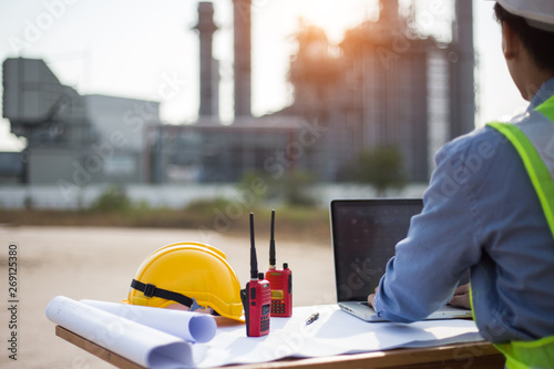tEngineer working and laptop at power plant