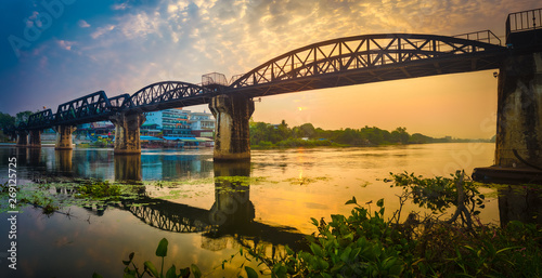 Fototapeta Naklejka Na Ścianę i Meble -  The bridge on the river Kwai at sunrise. Railway in Kanchanaburi, Thailand. Panorama