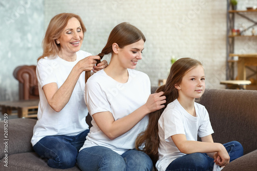 Happy family doing hair of ...