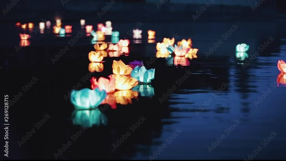 Running water flashlight. The glow of lanterns on the water at night. Romantic evening. Beautiful floating water lanterns. 