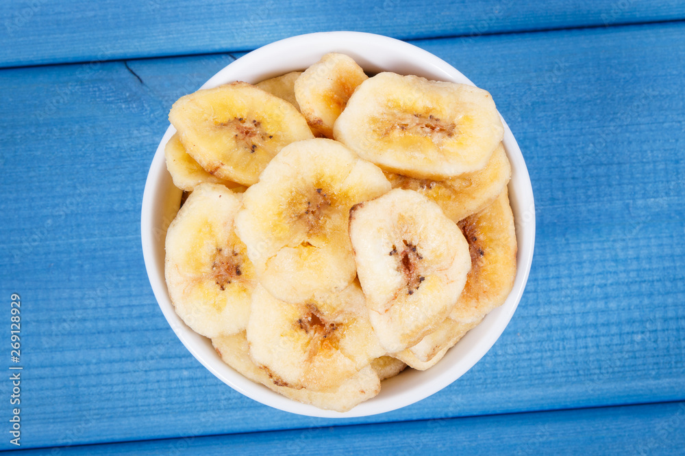 Homemade dried chips of banana for snack or dessert Homemade dried chips of banana for snack or dessert