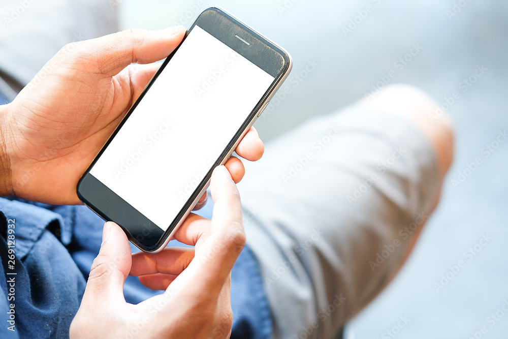 Cropped shot view of man hands holding smart phone with blank copy space screen for your text message or information content, female reading text message on cell telephone during in urban setting. Cropped shot view of man hands holding smart phone with blank copy space screen for your text message or information content, female reading text message on cell telephone during in urban setting.