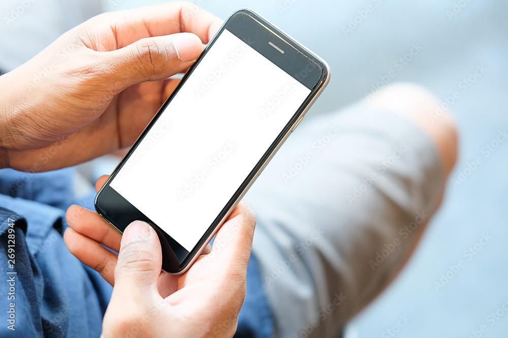 Cropped shot view of man hands holding smart phone with blank copy space screen for your text message or information content, female reading text message on cell telephone during in urban setting. Cropped shot view of man hands holding smart phone with blank copy space screen for your text message or information content, female reading text message on cell telephone during in urban setting.