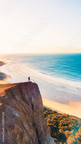 Aerial View of Beautiful Beach Coastline with Person on top of Cliffs Along the Great Ocean Road Australia